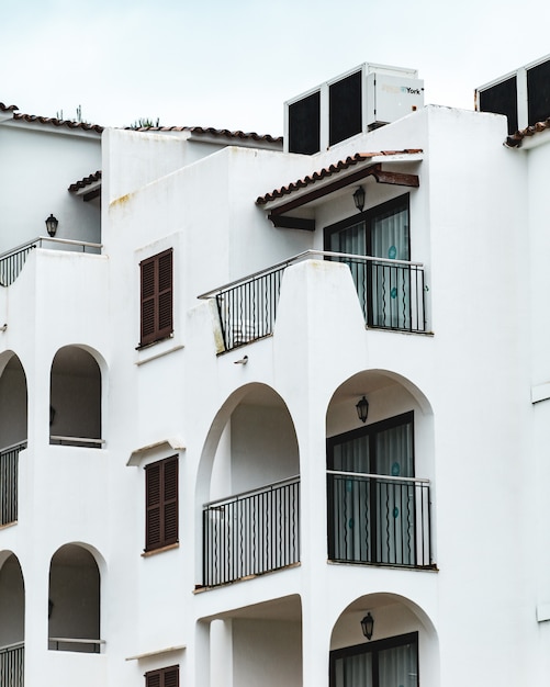 Free Photo vertical shot of the white building with several balconies