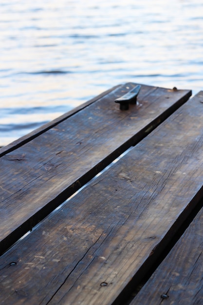 Free photo vertical shot of wooden boats above the water