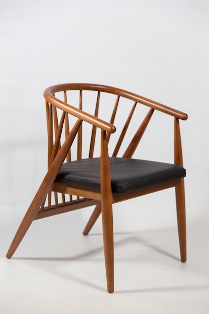 Free Photo vertical shot of a wooden chair behind a white