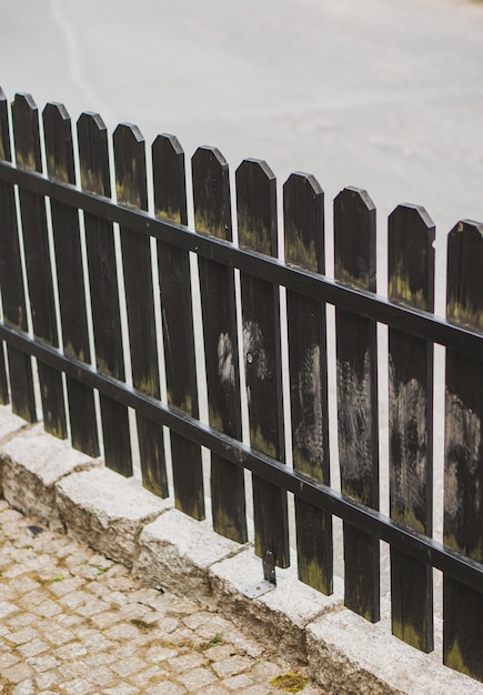 Free photo vertical shot of a wooden fence in the street