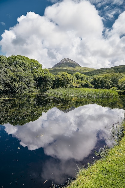 Free Photo vertical view of the connemara national park in mweelin ireland under a cloudy blue sky