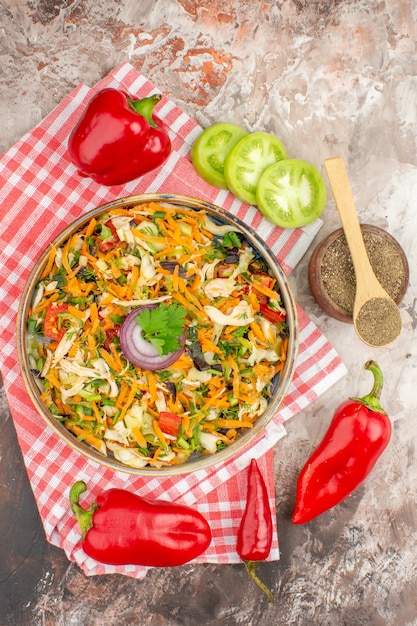 Vertical view of fresh delicious vegan salad of various organic vegetables and peppers