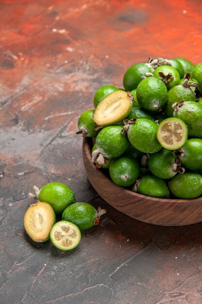 Vertical view of fresh natural whole and cut green feijoas