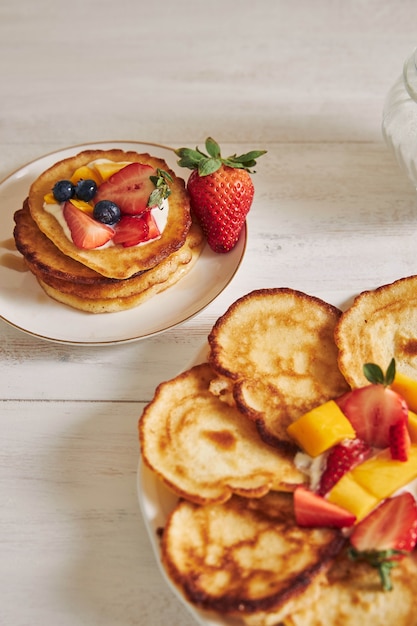 Vertical view of pancakes with fruits on the top