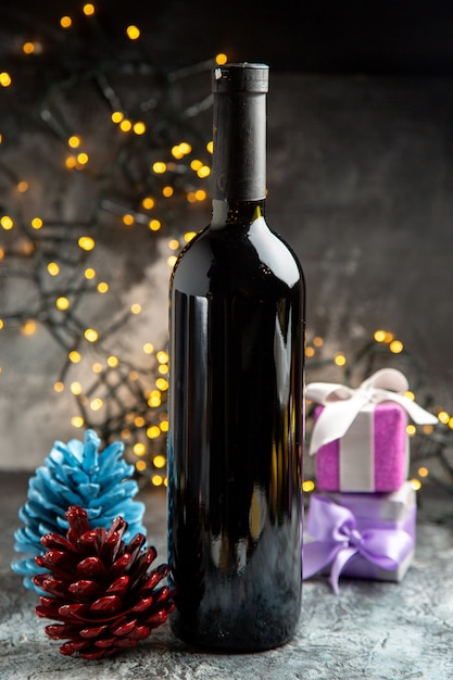 Vertical view of red wine bottle for celebration and gifts decoration accessories on gray background