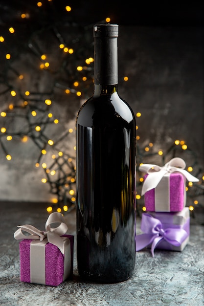 Vertical view of red wine bottle for celebration and gifts on gray background