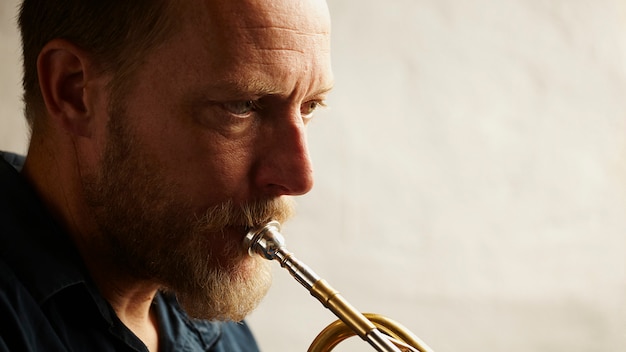 Free photo veteran musician playing the trumpet