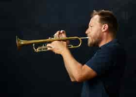 Free photo veteran musician playing the trumpet