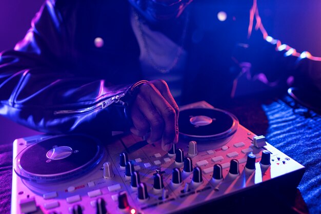 Vibrant scene with dj at a techno party