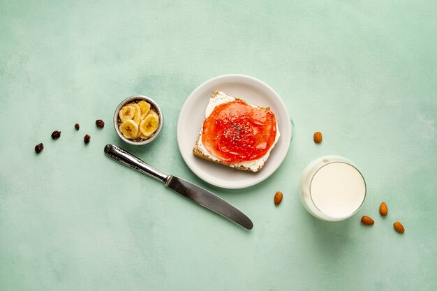 Above view arrangement with tasty breakfast on green background