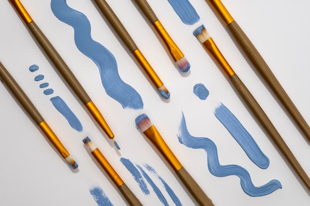 View of assortment of brushes with blue paint