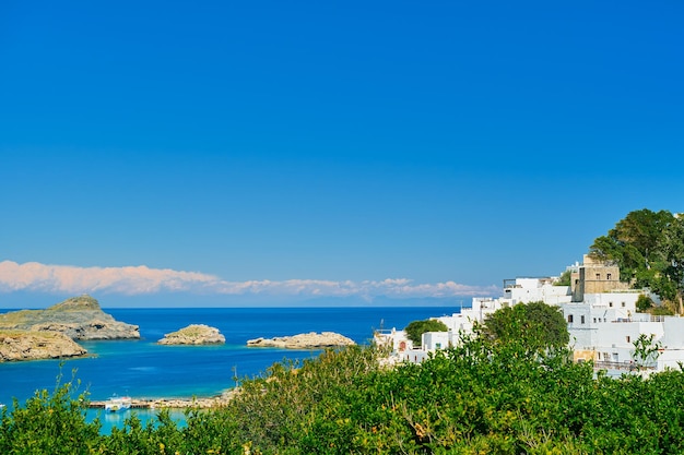 View of the bay and snowwhite houses of the ancient city of Lindos on the Greek island of Rhodes view of the Aegean Sea the islands of the Dodecanese archipelago Europe