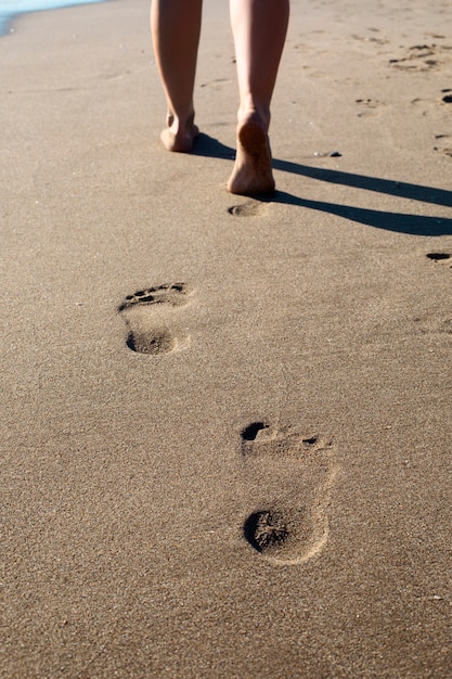 View of beach sand in summertime with footprints