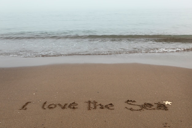 Free photo view of beach sand in summertime with message written in it