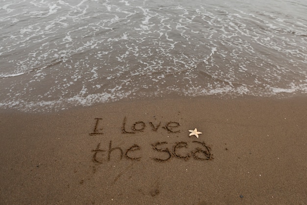 View of beach sand in summertime with message written in it