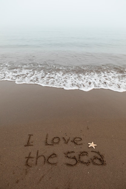 Free photo view of beach sand in summertime with message written in it