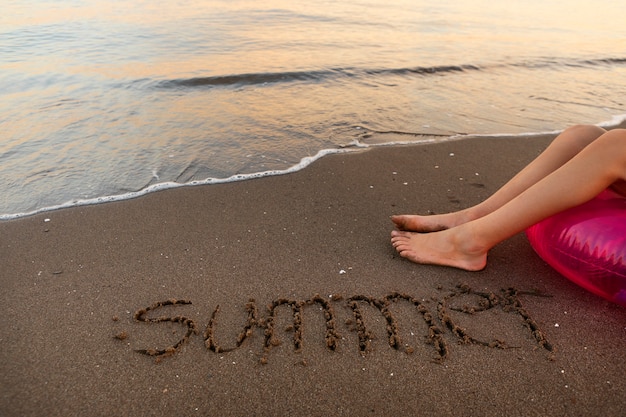 View of beach sand in summertime with message written in it