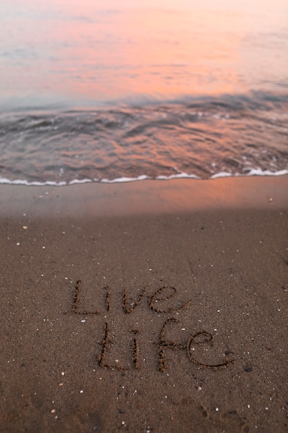 View of beach sand in summertime with message written in it