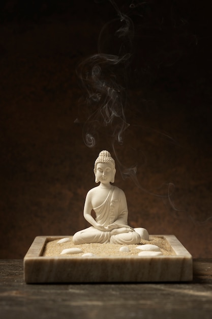 View of buddha statuette with incense