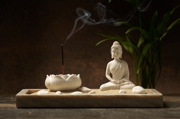 Free photo view of buddha statuette with incense