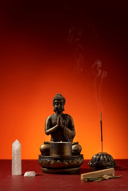 View of buddha statuette with incense