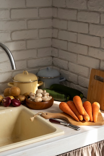 Free photo view of carrots in kitchen with other vegetables