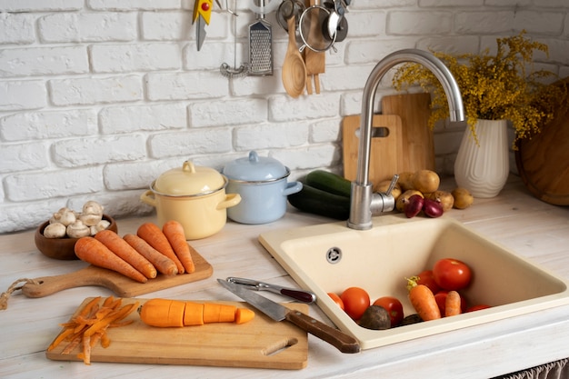 Free photo view of carrots in kitchen with other vegetables