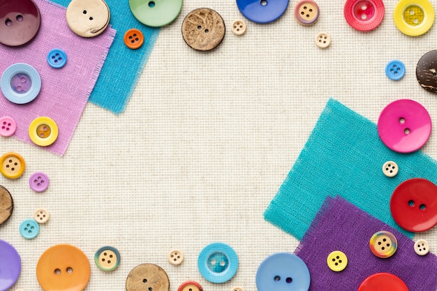 Above view colorful buttons on cloth pieces