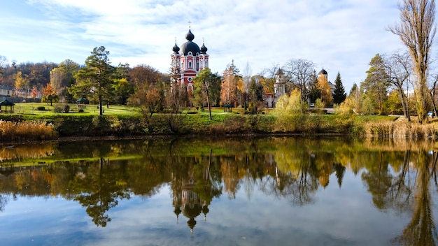 View of the Curchi monastery. The church and a park. A lake on the foreground. Moldova