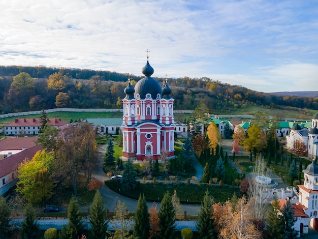 Free photo view of the curchi monastery from the drone. churches, other buildings, green lawns and walk paths. hills with greenery in the distance. moldova