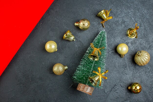 Above view of decoration accessories and christmas tree on dark background