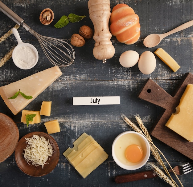 Free photo view of a delicious cheese platter with walnuts, eggs, and flour on the table with 