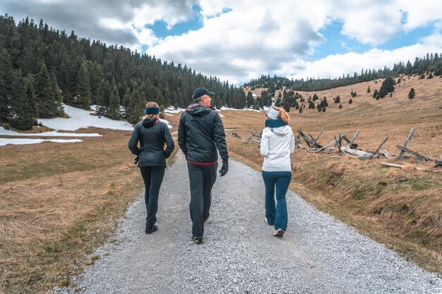 View of a European family walking on a rocky path during their touristic journey