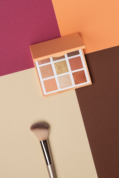 Free Photo view of eyeshadow palette with brush applicator