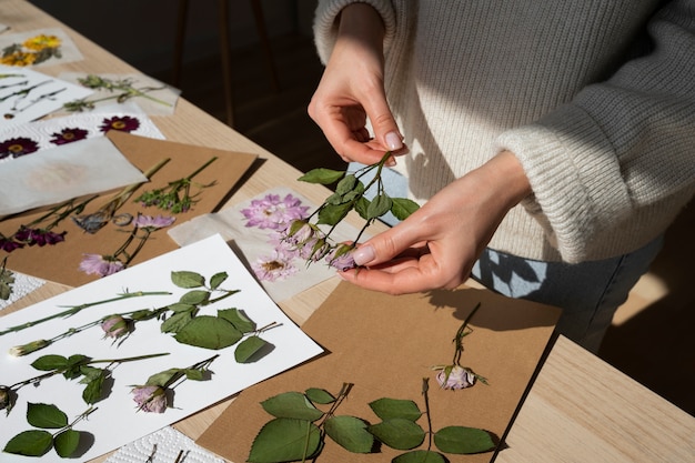 Free photo view of female artisan pressing flowers