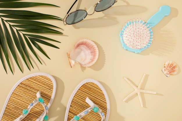 View of flip flops with summer essentials and hair brush