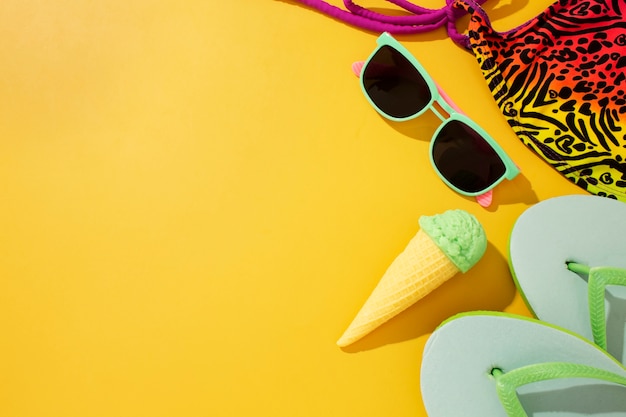 View of flip flops with summer essentials and ice cream