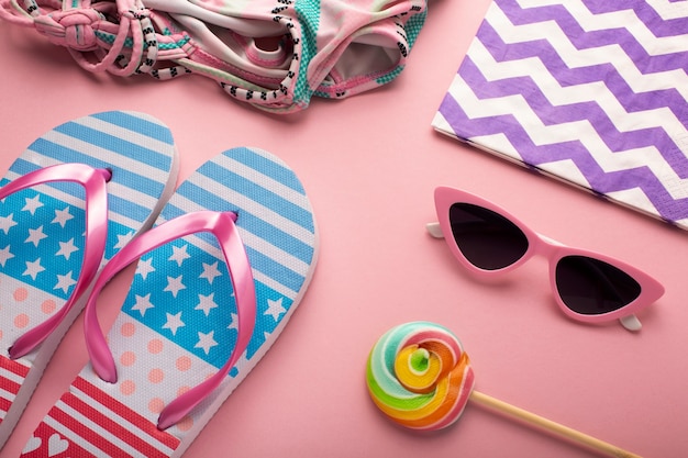 View of flip flops with summer essentials and lollipop