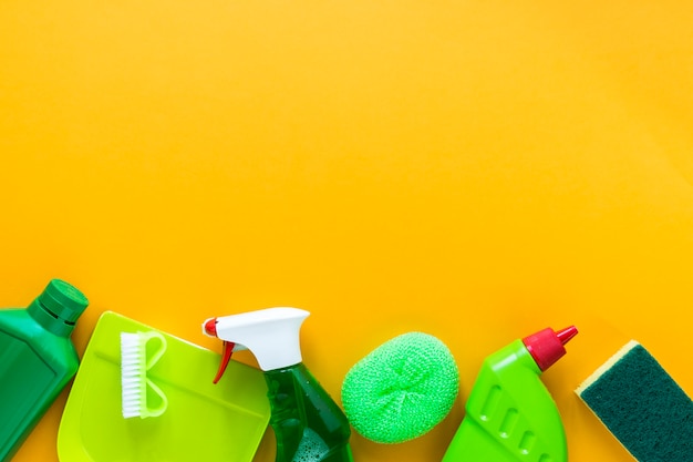 Above view frame with cleaning products on yellow background