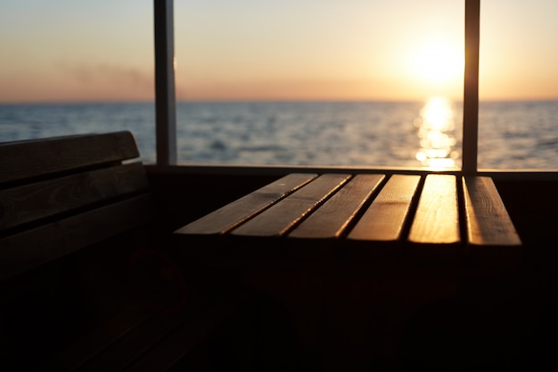 Free Photo view from deck of beautiful sunset. unrecognazible person having promenade on cruise ship, admiring beautiful landscapes