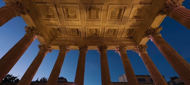 Free Photo view from maison carree by night raman temple in nimes