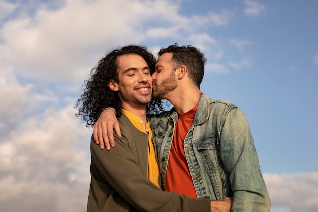 View of gay couple being affectionate and spending time together of the beach