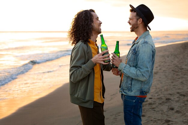 View of gay couple being affectionate and spending time together of the beach