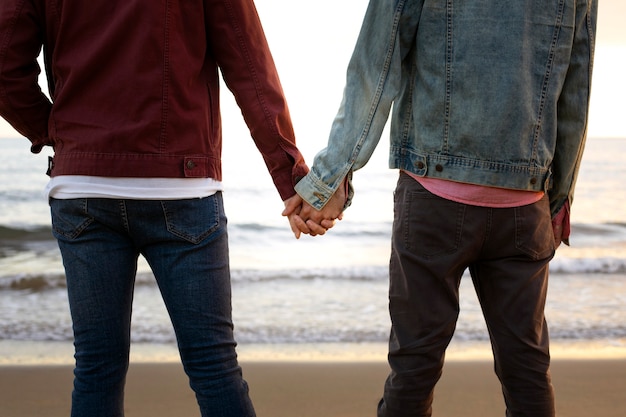 Free Photo view of gay couple being affectionate and spending time together of the beach