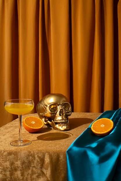 View of golden skull with citrus cocktail