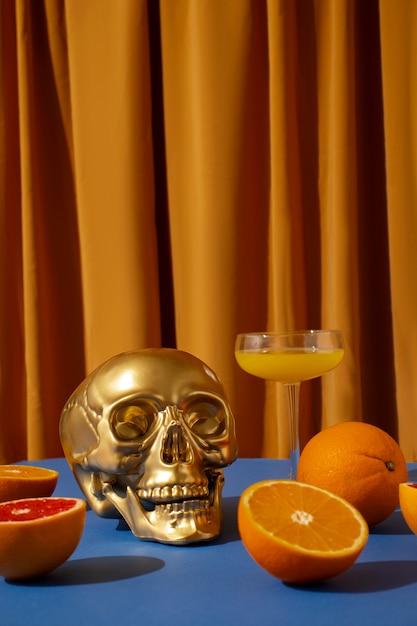 View of golden skull with citrus cocktail