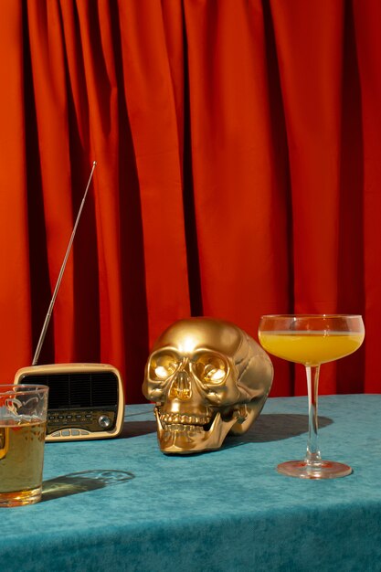 View of golden skull with citrus cocktail