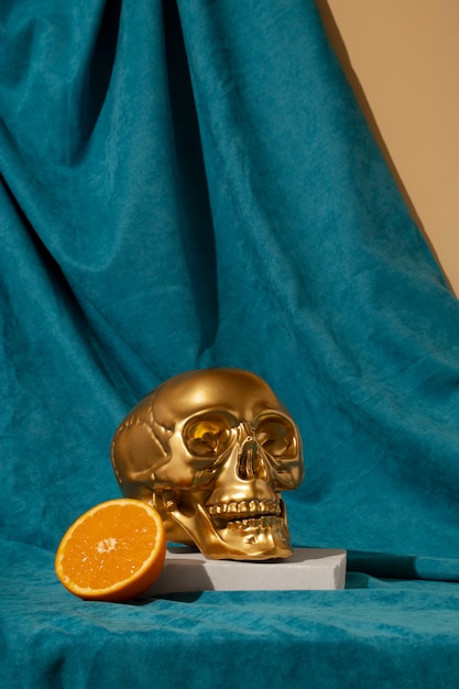 Free photo view of golden skull with citrus