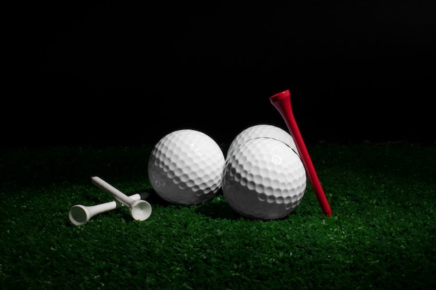 Free photo view of golf balls with tees