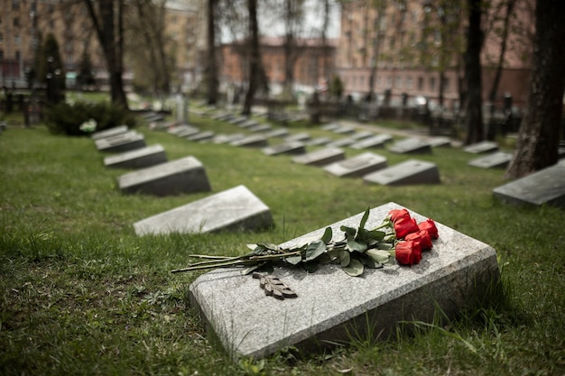 Free photo view of gravestone with flowers